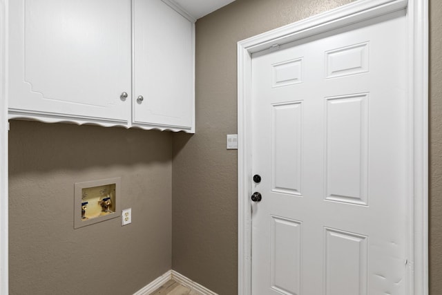 clothes washing area featuring cabinets and hookup for a washing machine