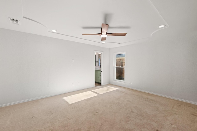 unfurnished room featuring light carpet and ceiling fan