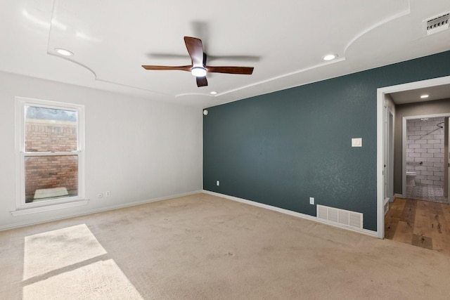 unfurnished room with ceiling fan and light colored carpet