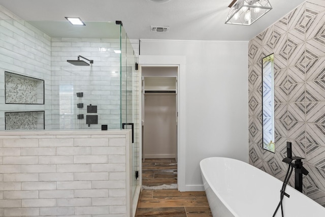 bathroom with shower with separate bathtub and crown molding