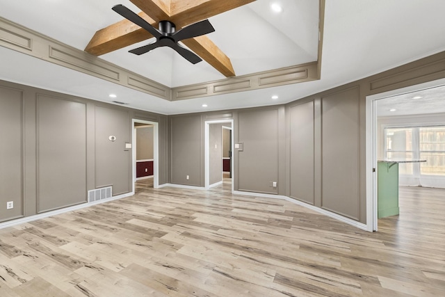 spare room featuring ceiling fan, beam ceiling, and light hardwood / wood-style flooring