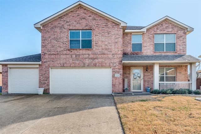 front of property with a garage, a front yard, and covered porch