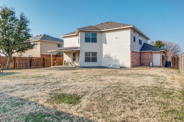 rear view of house featuring a shingled roof, central air condition unit, a yard, brick siding, and a fenced backyard