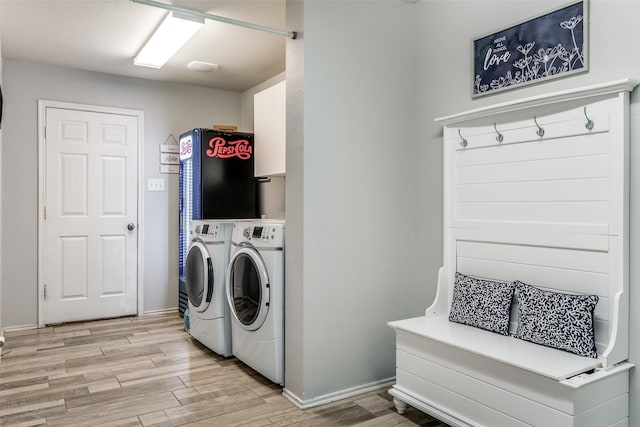 washroom featuring light hardwood / wood-style flooring and washer and dryer