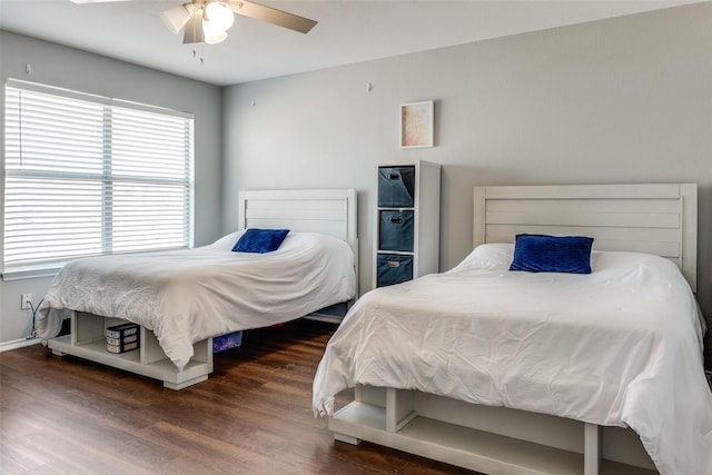bedroom with wood finished floors and a ceiling fan