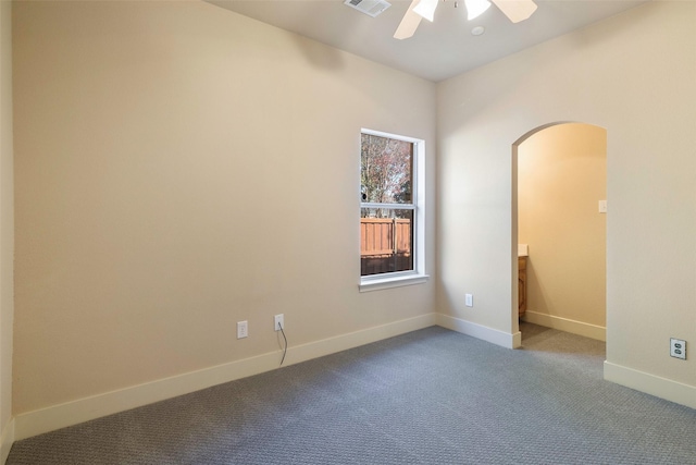 carpeted spare room with ceiling fan