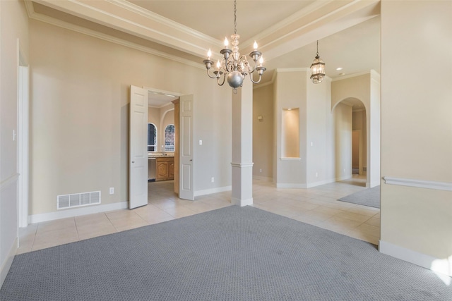 spare room featuring light tile patterned floors, crown molding, and a chandelier