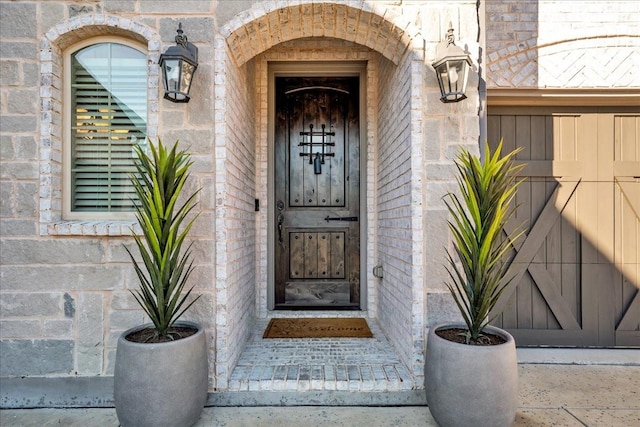 property entrance with stone siding and brick siding