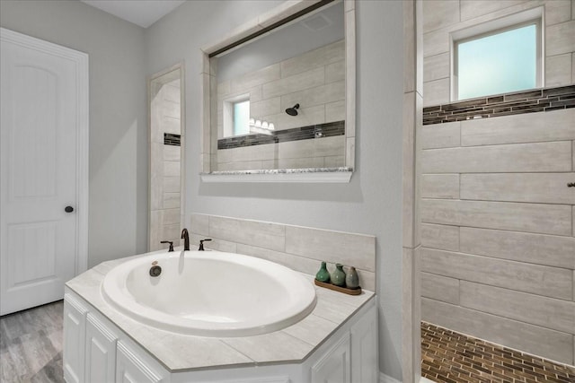 bathroom with wood-type flooring and plus walk in shower