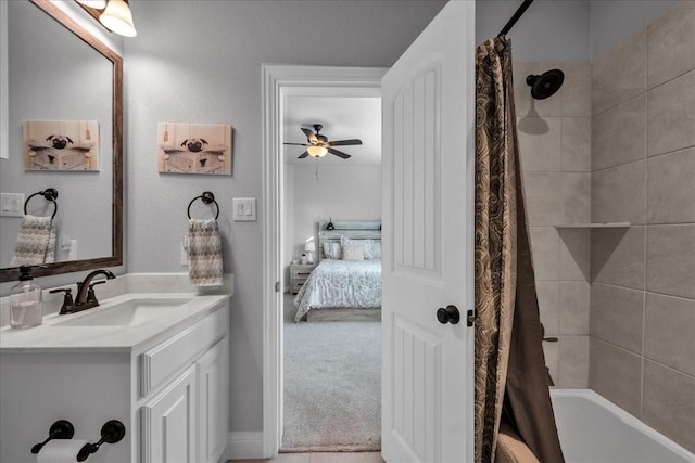 bathroom featuring vanity, shower / bath combo, and ceiling fan