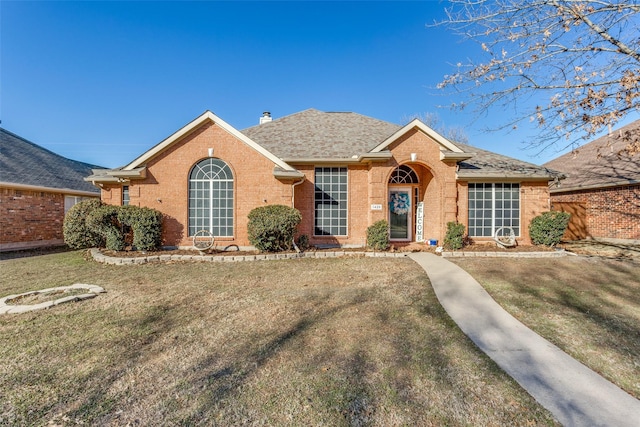 ranch-style house with a front lawn