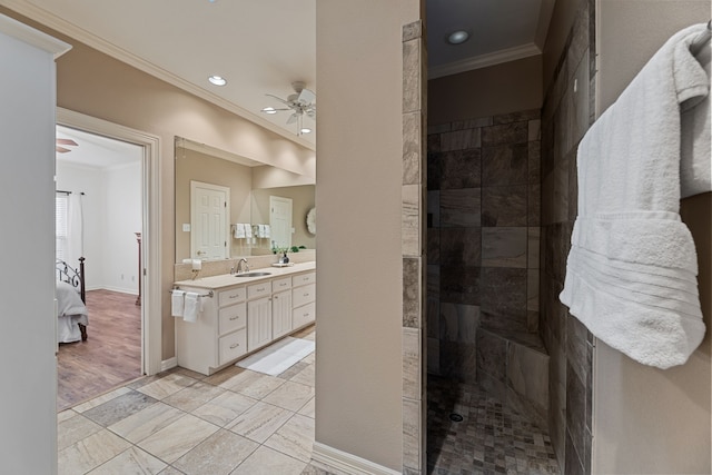 bathroom with a shower, vanity, ceiling fan, and ornamental molding