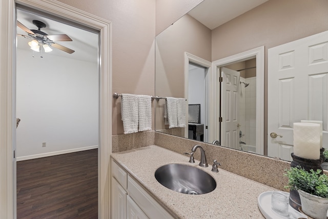 bathroom featuring bathing tub / shower combination, ceiling fan, vanity, and hardwood / wood-style flooring