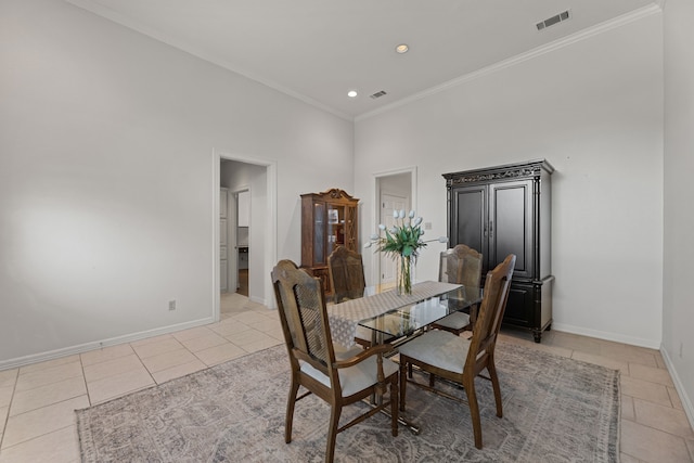 dining area featuring crown molding and light tile patterned flooring