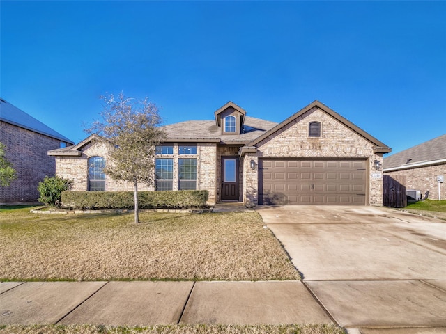 view of front of house with a front lawn and a garage