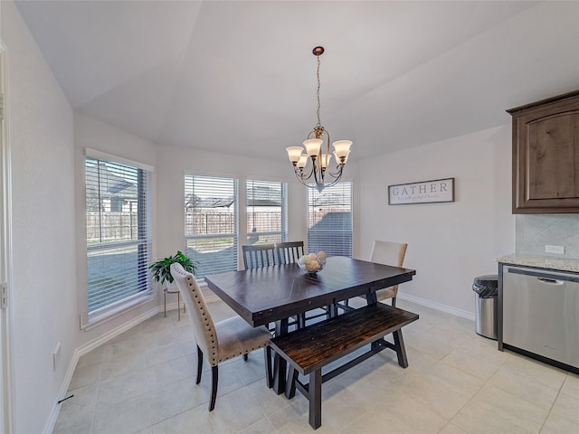 dining area with a chandelier, lofted ceiling, and light tile patterned flooring