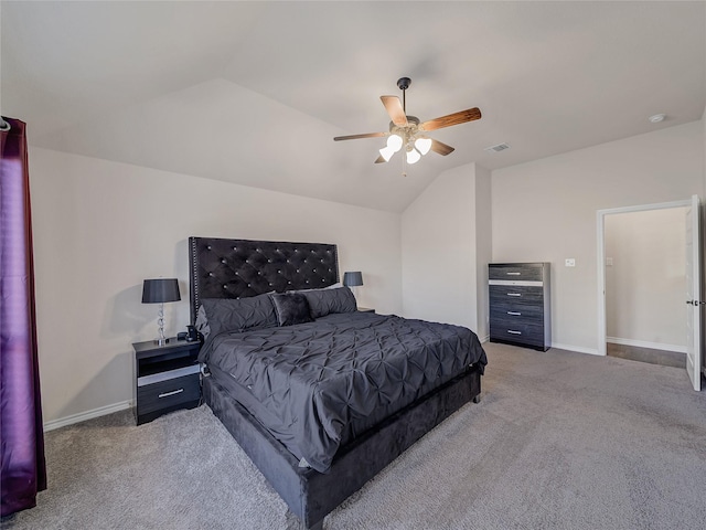 bedroom with ceiling fan, light colored carpet, and vaulted ceiling