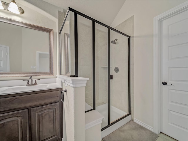 bathroom with vanity, an enclosed shower, and lofted ceiling