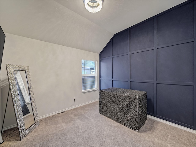 sitting room featuring light carpet and vaulted ceiling