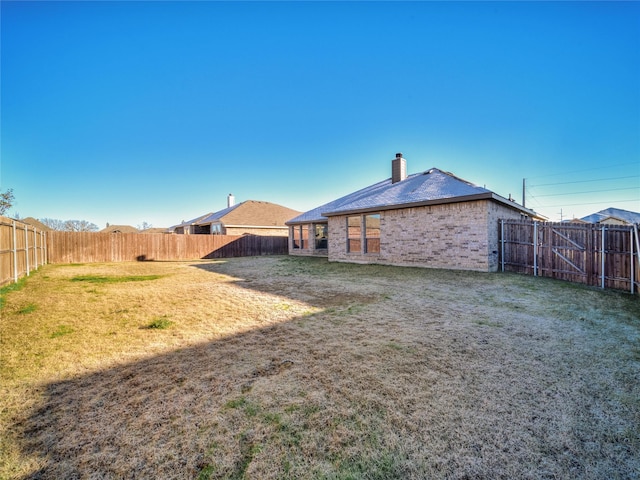 rear view of property featuring a lawn