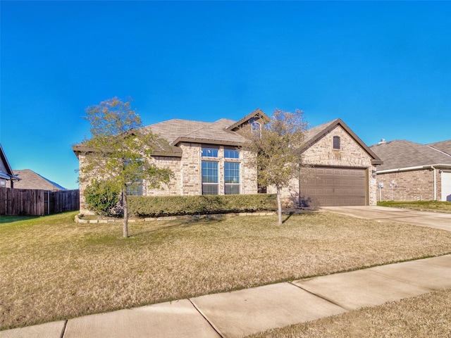 view of front of home with a garage and a front lawn