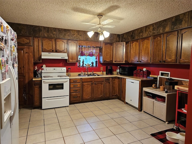 kitchen featuring ceiling fan, sink, a textured ceiling, white appliances, and light tile patterned floors