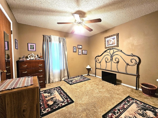 bedroom with carpet flooring, ceiling fan, and a textured ceiling