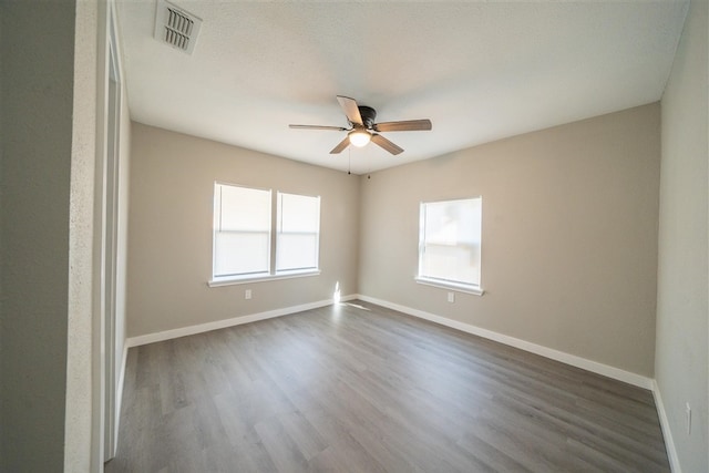 unfurnished room with dark hardwood / wood-style floors and ceiling fan