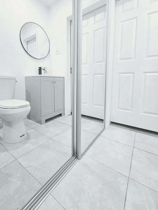 bathroom with tile patterned floors, vanity, and toilet