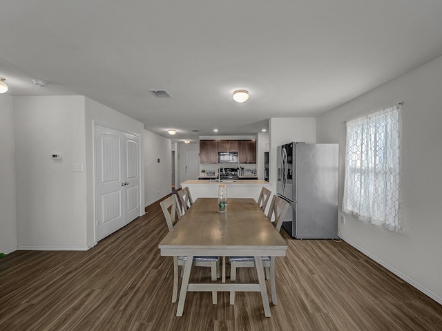 dining room with dark hardwood / wood-style flooring