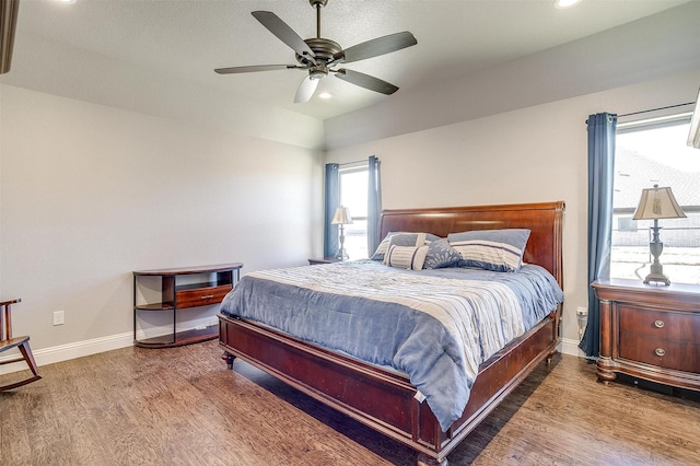 bedroom featuring hardwood / wood-style flooring, ceiling fan, and lofted ceiling