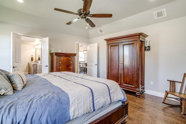 bedroom featuring ceiling fan, dark hardwood / wood-style flooring, lofted ceiling, and connected bathroom