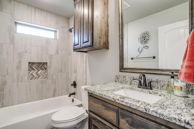 full bathroom with toilet, vanity, and tiled shower / bath