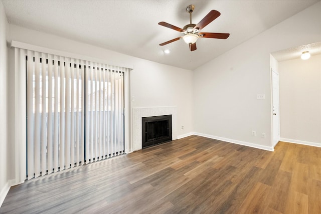 unfurnished living room featuring ceiling fan, hardwood / wood-style floors, and vaulted ceiling