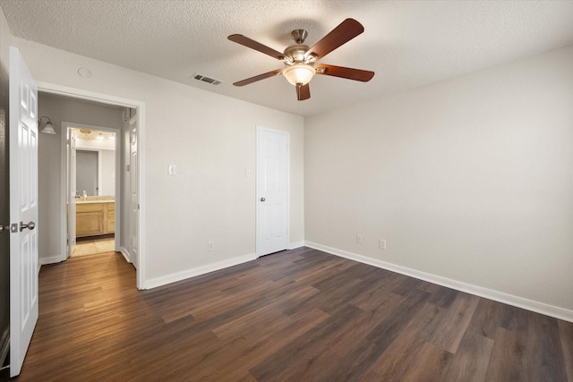 spare room featuring a textured ceiling, dark hardwood / wood-style flooring, ceiling fan, and sink