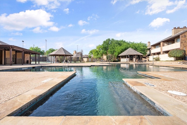 view of swimming pool featuring a gazebo and a patio