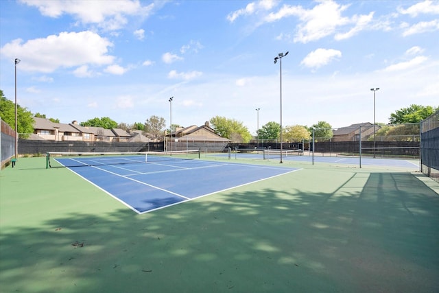 view of tennis court featuring basketball court