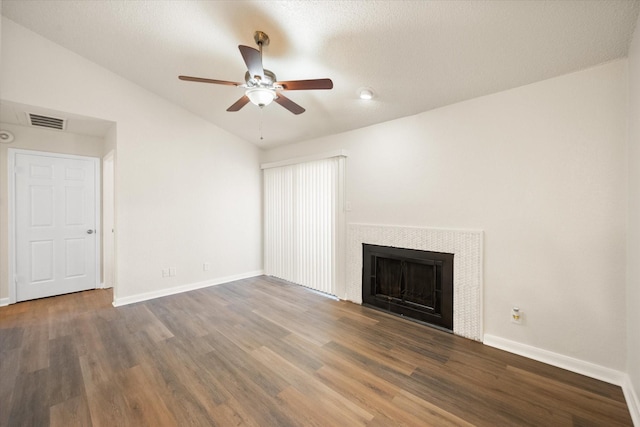 unfurnished living room with ceiling fan, dark wood-type flooring, and vaulted ceiling