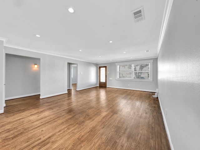 unfurnished living room featuring hardwood / wood-style floors and ornamental molding