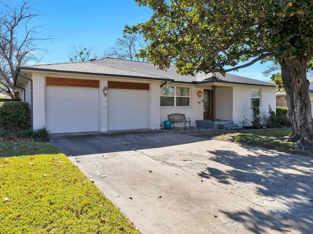 single story home with a front lawn and a garage