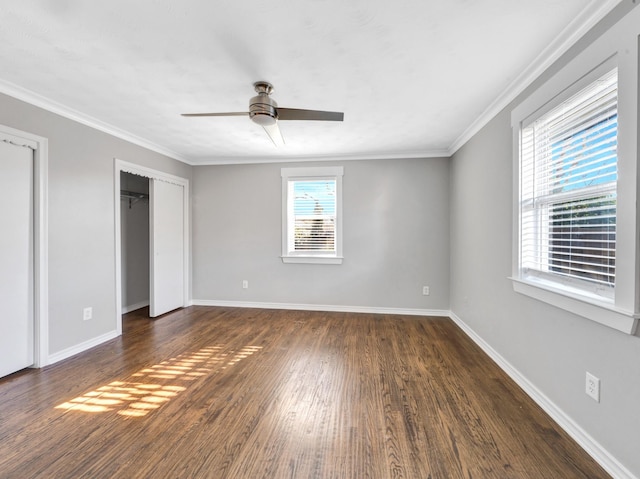 unfurnished bedroom with dark hardwood / wood-style flooring, ceiling fan, and crown molding