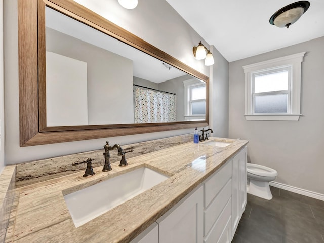 bathroom featuring a shower with shower curtain, vanity, toilet, and a healthy amount of sunlight