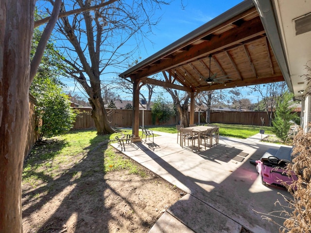 view of yard with ceiling fan and a patio