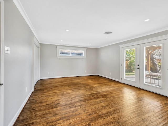 spare room featuring french doors, dark wood-type flooring, and ornamental molding