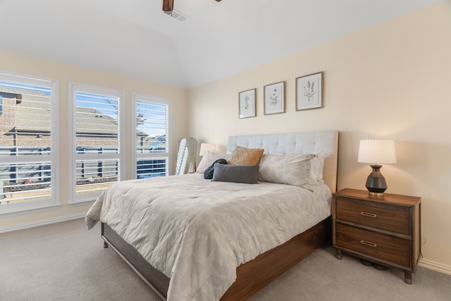 bedroom featuring ceiling fan, light colored carpet, and vaulted ceiling