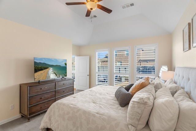 carpeted bedroom featuring a raised ceiling, ceiling fan, and vaulted ceiling