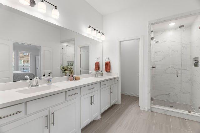 bathroom featuring tile patterned floors, vanity, and a shower with shower door