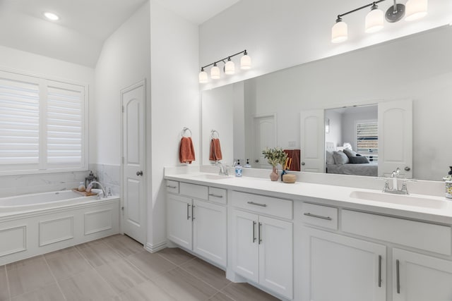 bathroom with a tub to relax in and vanity