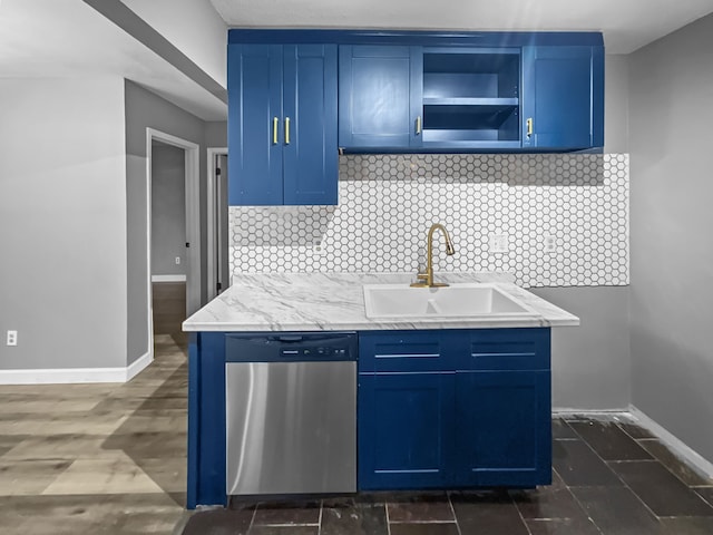 kitchen featuring stainless steel dishwasher, blue cabinetry, and sink