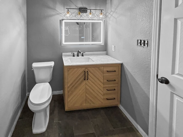 bathroom featuring toilet and vanity